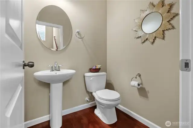 A half bath with pedestal sink on the main level.