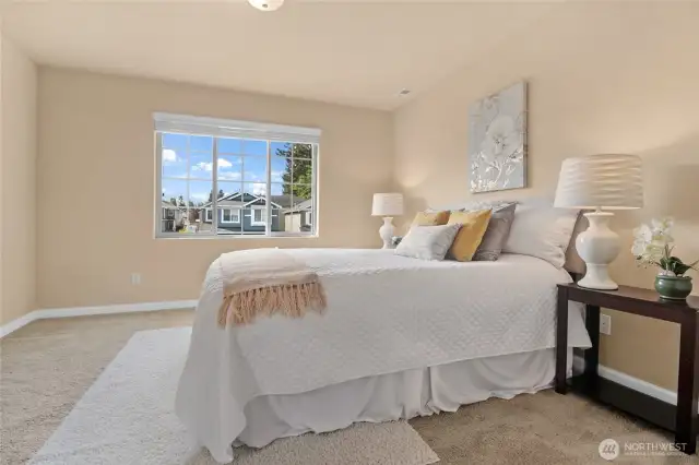 The window in the primary bedroom lets in wonderful natural light.