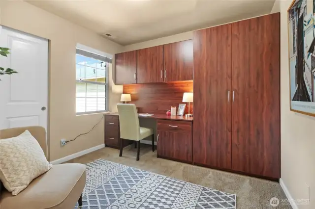 This bedroom upstairs has a built-in desk system.