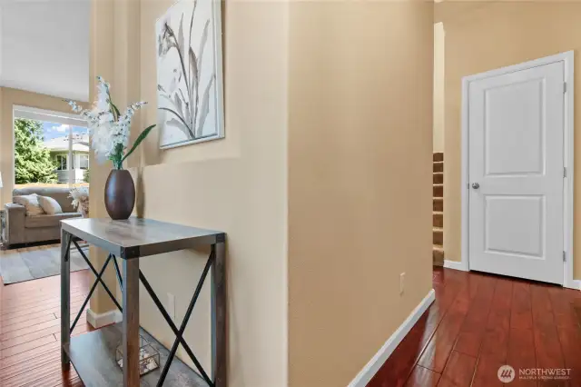 An art niche adds drama to the entryway. The hall splits in two directions offering options to different areas of the home.