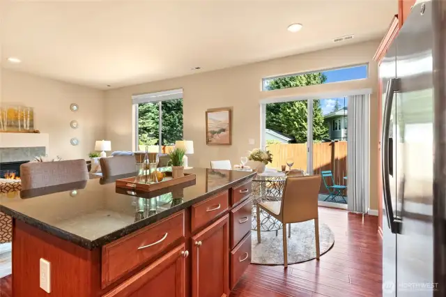 A kitchen island with granite countertop adds to the entertaining space.