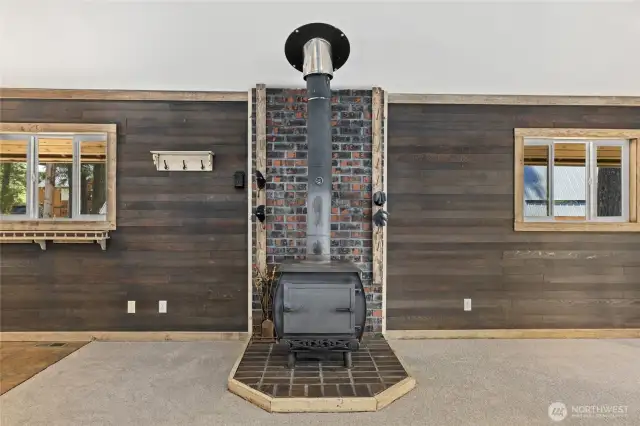 Freestanding wood burning stove.  On both sides there are pegs for drying your gloves and mittens in the winter.
