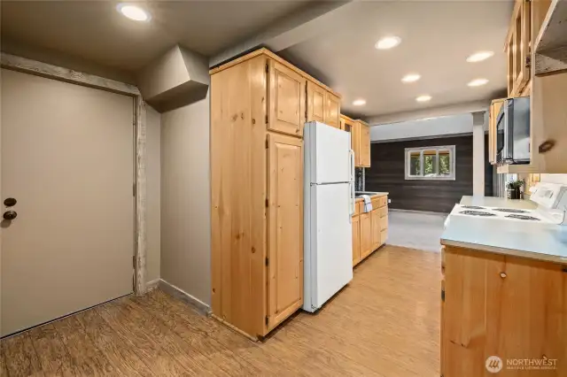 Kitchen view showing access to the garage from den/office area.