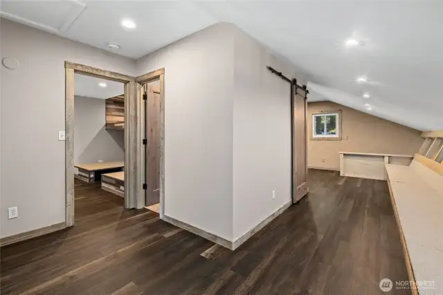 Upstairs loft area with seating and facing the bunkroom and upstairs bathroom.