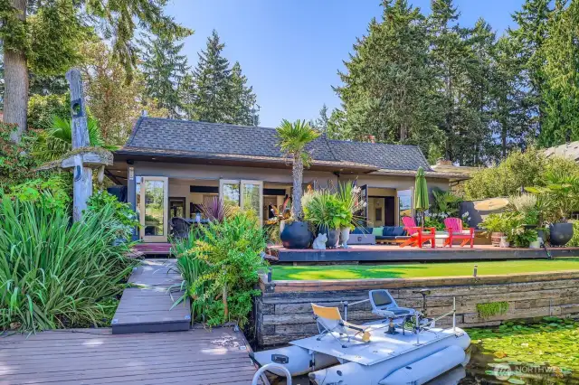 Look back at your lush landscape from the private floating dock. Custom Native American Art piece (paperwork provided), multi-area deck perfect for entertaining, turf lawn area, and room for all your water toys. Lake allows kayaks, paddle boards, row boats, small sail craft, electric powered motors, swimming, and is stocked with trout and bass.