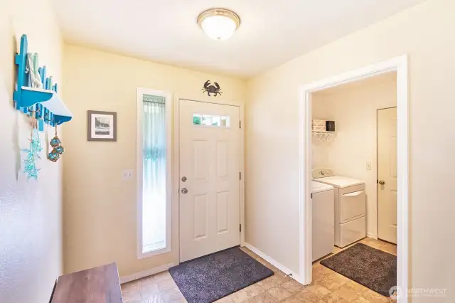Welcoming entryway with laundry adjacent, leading to the oversize garage.