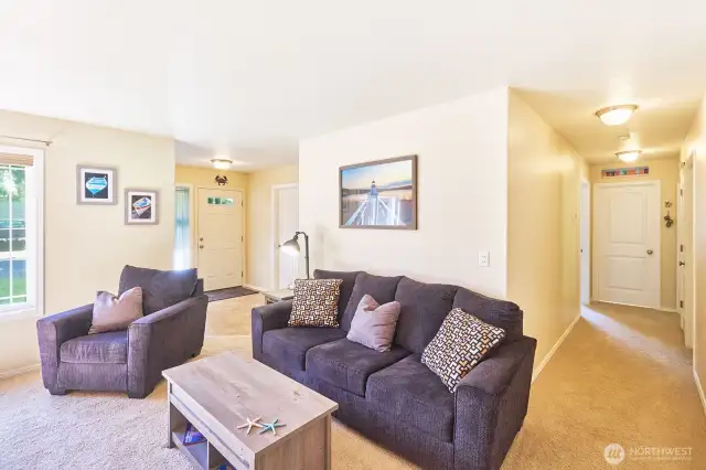 Spacious open concept living room with bedrooms beyond.