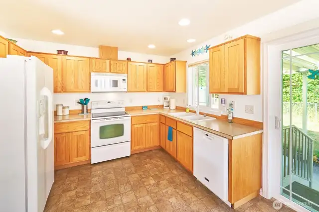 Kitchen has pretty cabinets and a functional layout.