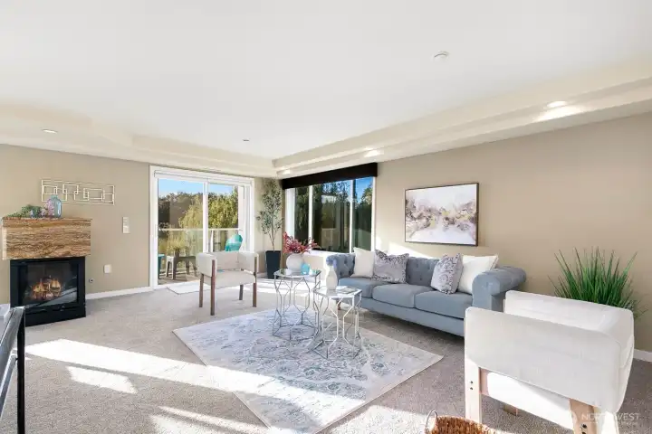 Wonderful living area with 3 sided gas fireplace that leads to patio and SUNSET views