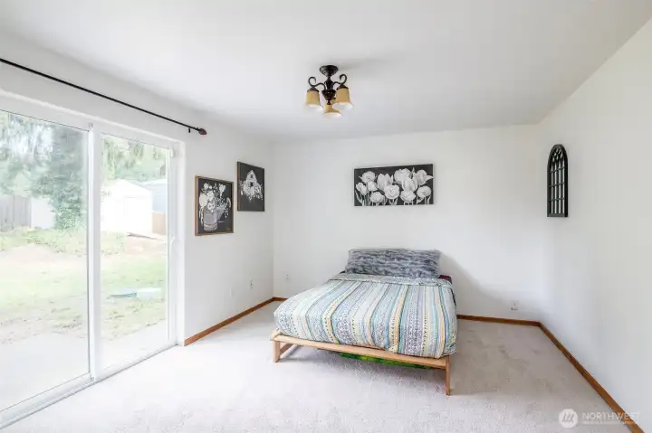 Make this room whatever you want it to be! it's located on the main floor, just past the kitchen. And as you can see, it has a sliding glass door, providing access to the back yard.