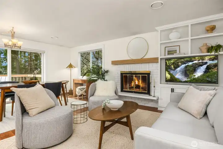 The main level features an open floorplan with new built-ins next to the fireplace.
