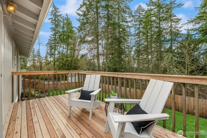 Enjoy peaceful views from the sunny, west-facing deck that overlooks the wonderful yard with established gardens.  You also get peek-a-book views of the Olympic Mountains and gorgeous sunsets!