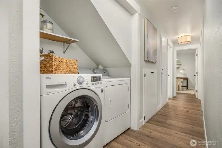 Laundry area is nicely tucked away under the stairs.