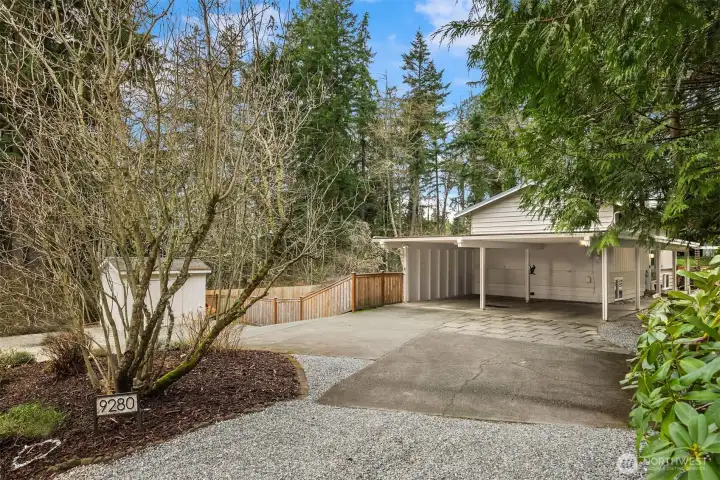 The expansive circular driveway ensures plentiful parking and smooth, convenient access.  Don't miss the spacious outdoor shed on the left!