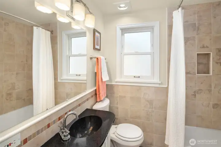 The main floor bathroom has been nicely updated with new tile and fresh paint.