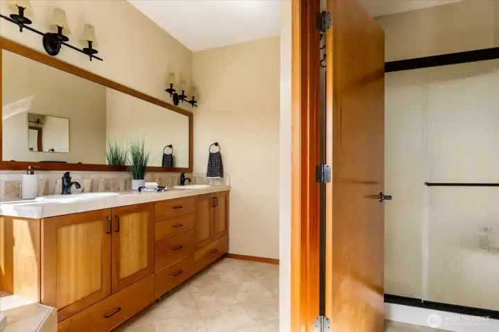 Dual sinks and a separate toilet and shower pair functionality with quality.