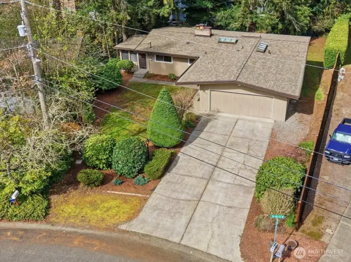 View from above. Tons of parking and room to park a car or small car/RV/Boat to right of garage.