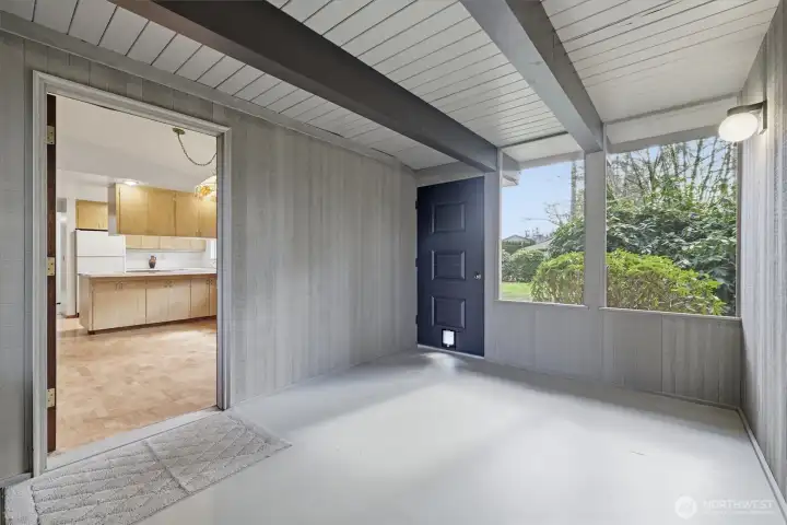 Enclosed, open air completely finished screen window room off eating area.