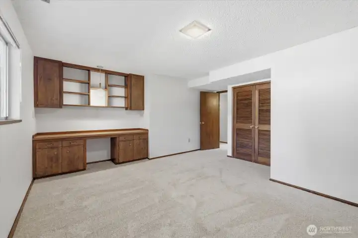 Lower Large bedroom with custom built-in desk-cabinets, could be additional closet.