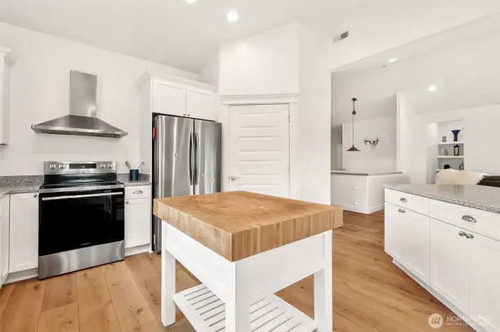 Updated kitchen with butcher block island and breakfast bar