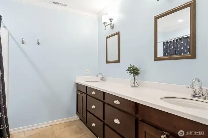 Large bathroom on lower level with dual vanity and tub/shower conmbo