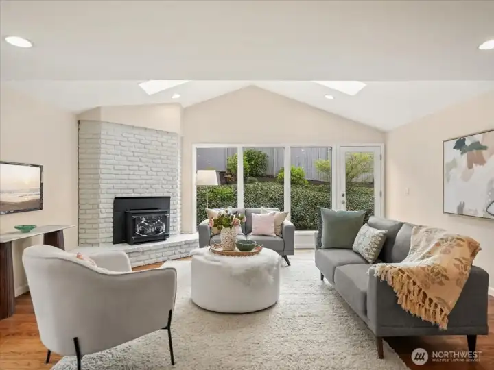 Vaulted ceilings elevate the family room, while skylights and west-facing windows flood the space with natural light throughout the day.