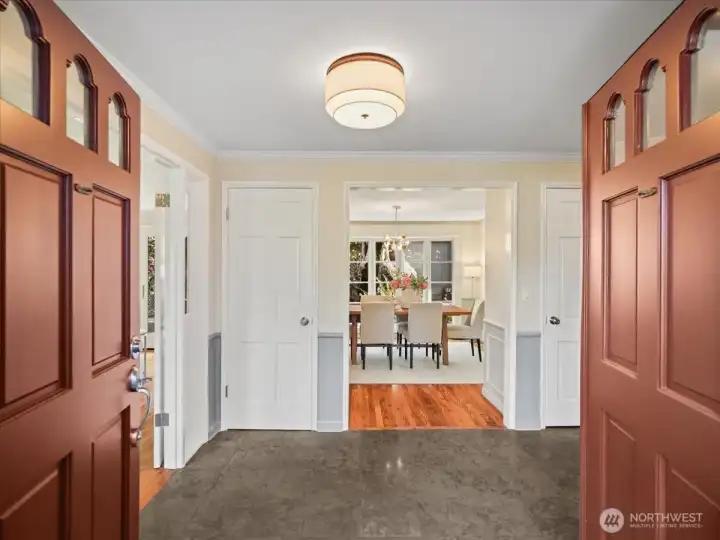 Through double front doors, a welcoming entry unfolds—effortless access to both the formal living and dining rooms.