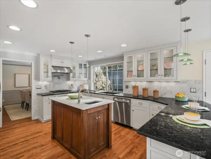The kitchen island features a prep sink and a beautiful marble countertop—perfect for everyday living and entertaining alike.