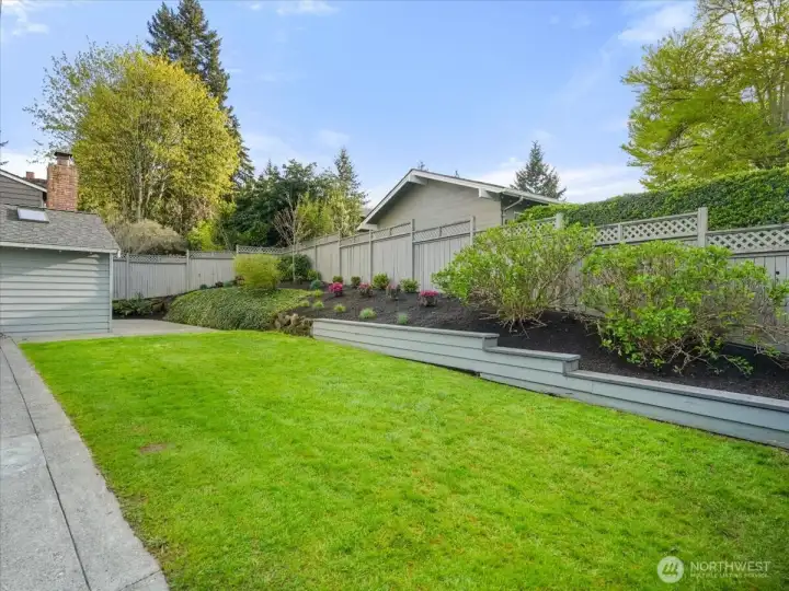 A flat, grassy, sun-filled yard just off the family room offers the perfect space for play.