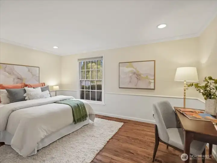 On the main level, a bright and versatile room serves beautifully as a bedroom or home office, with a convenient adjacent bathroom.