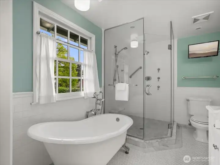 From the soaking tub, bask in natural light from the skylight above or unwind with your favorite movie on the nearby TV.
