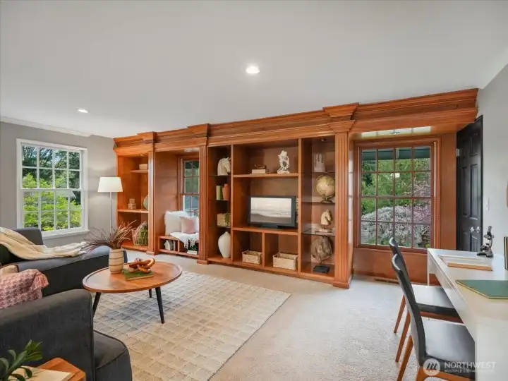 Stunning custom built-in bookcases offer abundant storage and a beautiful centerpiece for an entertainment area.