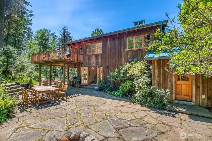 Multiple private spaces surround the home and gardens.