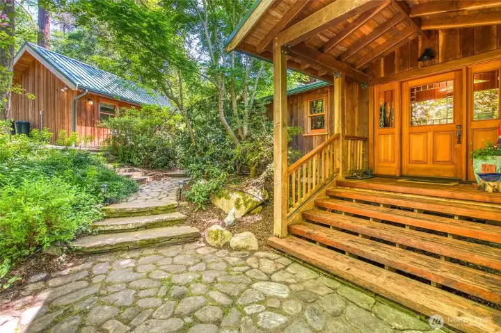 Front entry with over two fenced acres surround the home and studio.