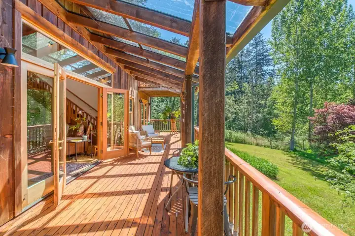Living room deck with glass covered porch ceiling offers additional light.