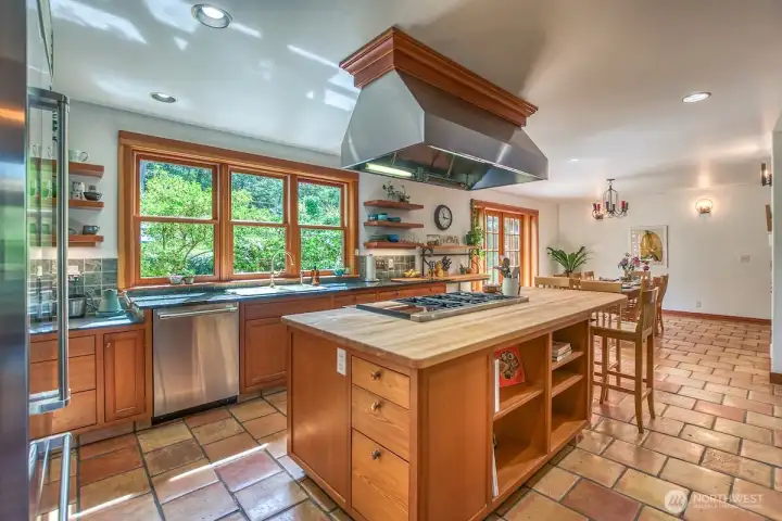 Spacious kitchen and prep areas for gathering with friends. Nearby laundry room and large pantry with Subzero freezer and built-in counters with storage for supplies and stored goods.