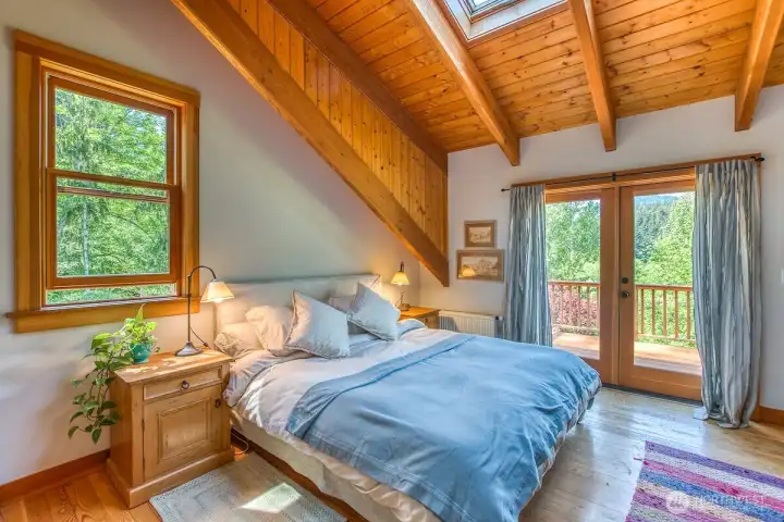 Upstairs bedroom with French doors and ensuite bath.