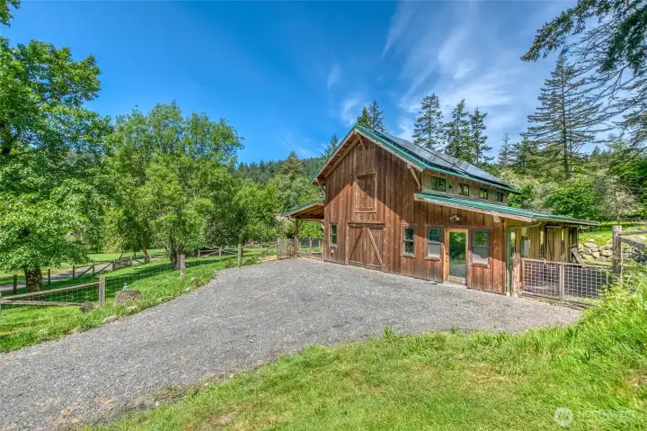 Custom barn built in 2018 features a fenced acre and interior and exterior spaces for animals and mini dairy prep. Water, power and solar installed.