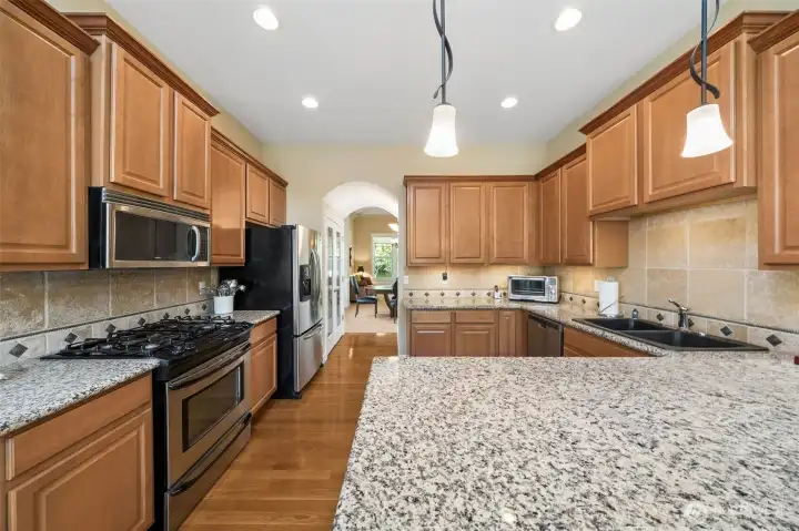Kitchen with gas range, granite counters and all appliances stay!
