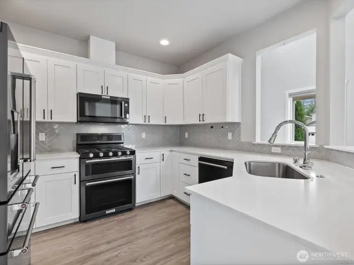 Slab quartz countertops. Double oven.