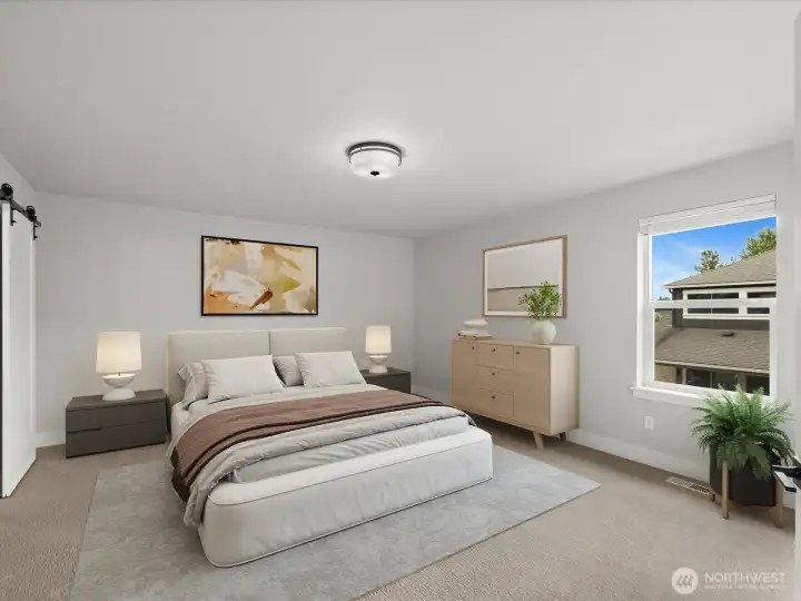 Enter the primary suite through French doors and the ensuite bath through a sliding barn door.