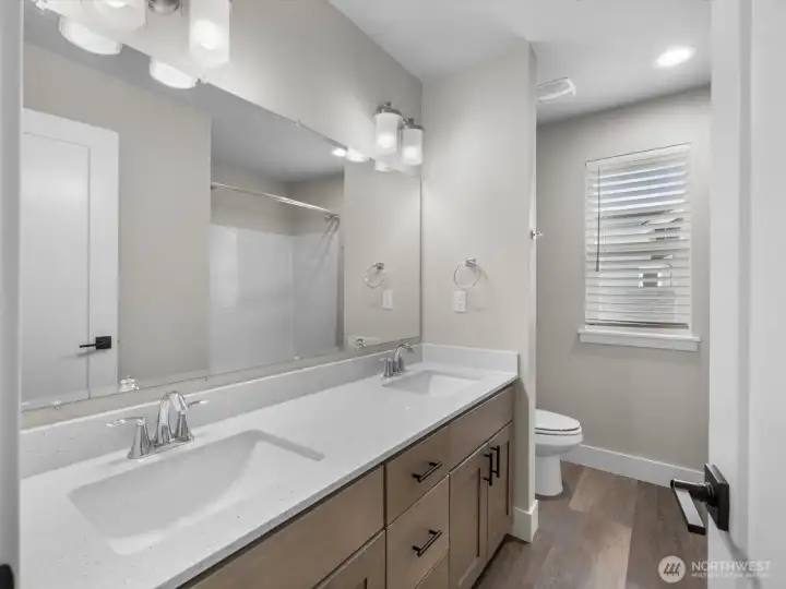 Full guest bath upstairs also has dual sinks.