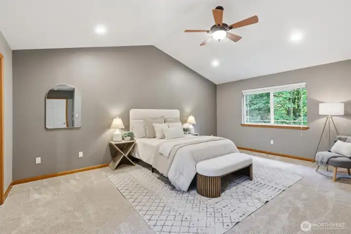Primary retreat overlooking backyard with vaulted ceiling, ceiling fan, 5-piece ensuite bath and walk-in closet.