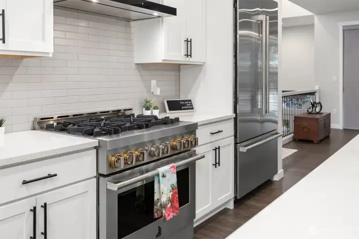 Stunning 6 burner high end gas Jenn Air range and built in refrigerator.