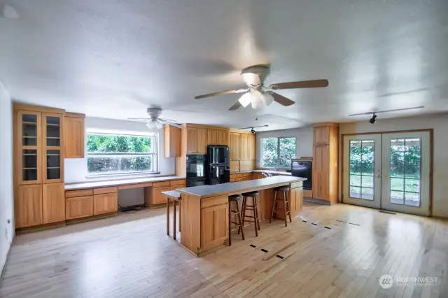 Large Light filled Kitchen. Cabinets are decent and Hardwood floors