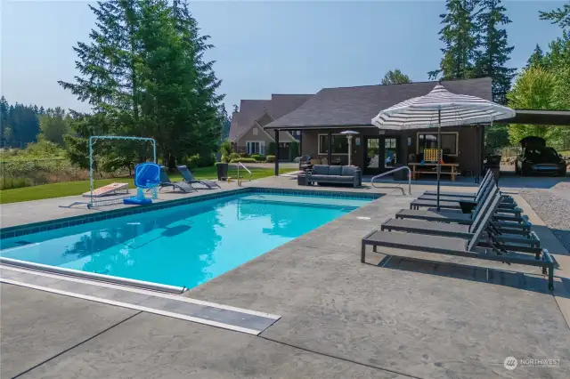 Great pool decking surrounding the pool is perfect for laying out and relaxing.