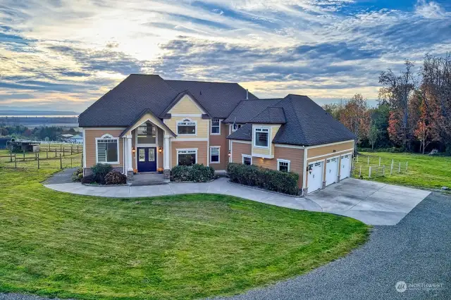 The home sits majestically atop a hill on a private drive with views of the Puget Sound, Islands and the snowcapped Olympic Mts