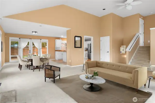 View of the main living space and dining area in the background. Upstairs is a bedroom, full bath, & office nook.