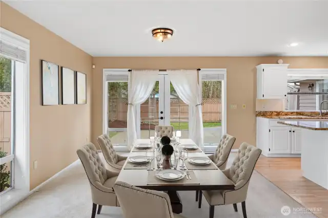 This virtually stage photo shows how spacious the dining area is. The French doors lead to the fenced patio/courtyard, perfect for pets and privacy.