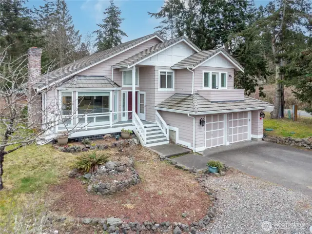 This well-designed home has an oversized two-car garage, a trek-like front deck and spacious yard with fruit tress and more.